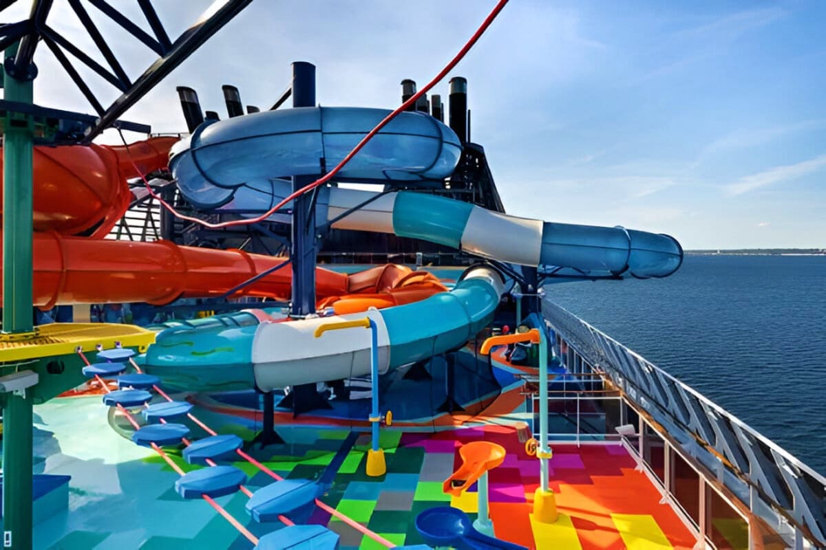 Colorful water slides and deck area on MSC Euribia cruise ship overlooking ocean and coastline